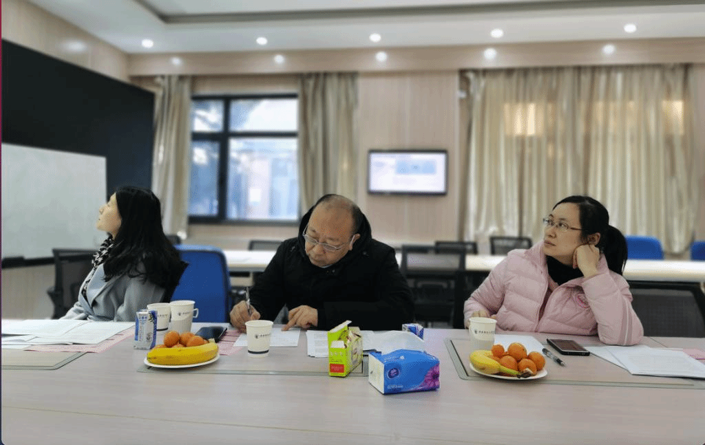 A group of people sitting at a tableDescription automatically generated with medium confidence